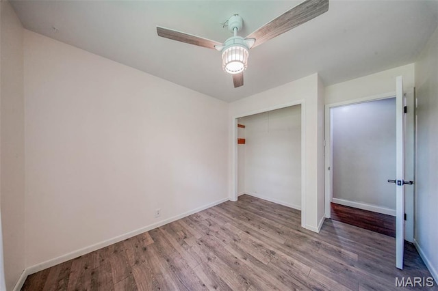 12575 State Route F, Rolla, MO 65401 - unfurnished bedroom featuring wood finished floors, a ceiling fan, and a closet