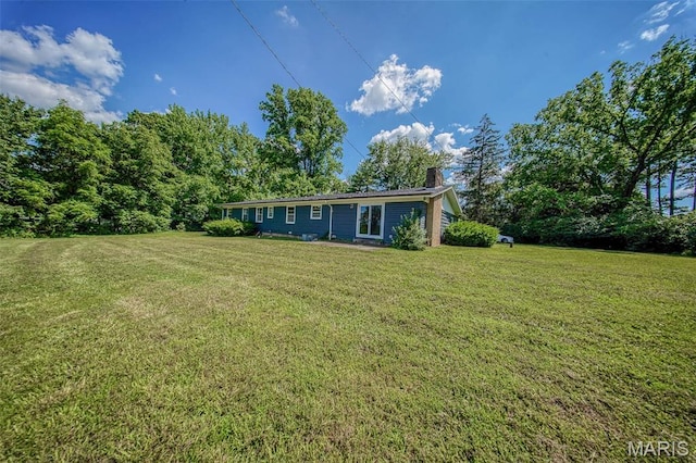 12575 State Route F, Rolla, MO 65401 - rear view of house with a chimney and a lawn