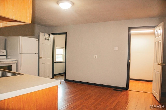 908 Birch St, Leadwood, MO 63653 - kitchen featuring wood finished floors, white appliances, and light countertops