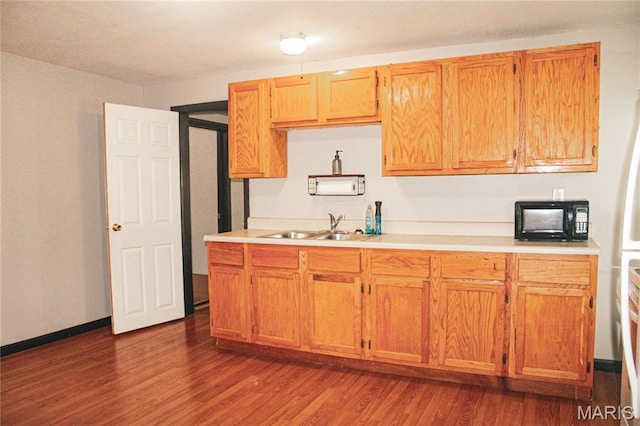 908 Birch St, Leadwood, MO 63653 - kitchen with black microwave, dark wood-style floors, light countertops, and brown cabinets