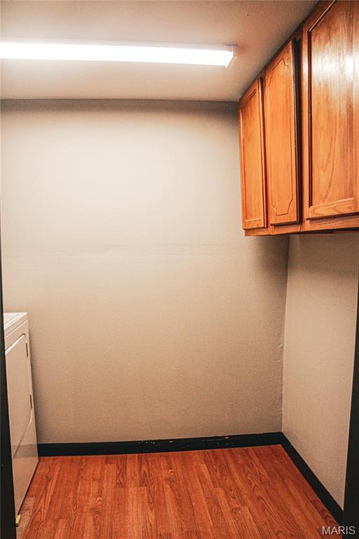 908 Birch St, Leadwood, MO 63653 - washroom featuring cabinet space, washer / dryer, and dark wood-type flooring