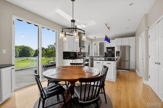 612 Thornridge Dr, Ofallon, MO 63368 - dining space with light wood-style floors and a chandelier