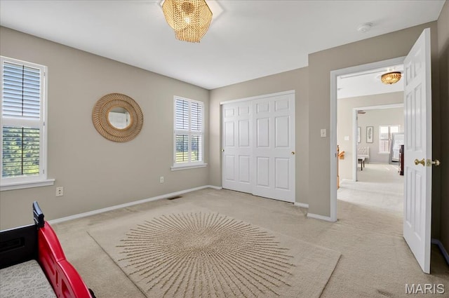 612 Thornridge Dr, Ofallon, MO 63368 - unfurnished bedroom featuring carpet floors, multiple windows, and a closet