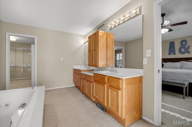 612 Thornridge Dr, Ofallon, MO 63368 - ensuite bathroom with double vanity, a ceiling fan, and a whirlpool tub