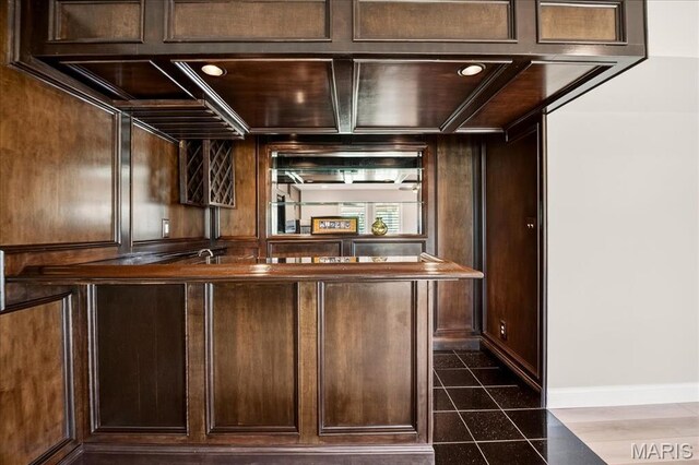 612 Thornridge Dr, Ofallon, MO 63368 - bar featuring dark tile patterned floors and baseboards