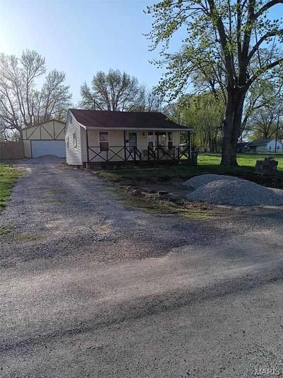 305 Stephenson Ave, South Roxana, IL 62087 - view of front of house featuring covered porch and a garage