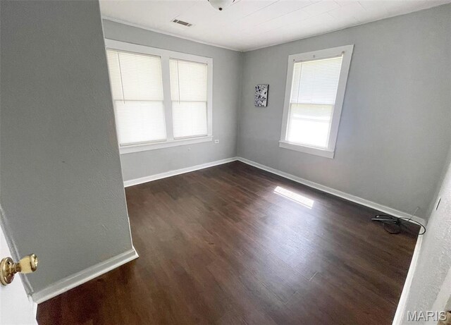 1309 E E Oak St, Dexter, MO 63841 - spare room featuring dark wood-style floors