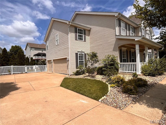 114 Cloverleaf Meadows Ct, Ofallon, MO 63366 - view of side of home with covered porch, a garage, and concrete driveway
