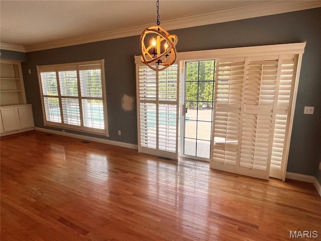 114 Cloverleaf Meadows Ct, Ofallon, MO 63366 - unfurnished dining area with wood finished floors, crown molding, and a chandelier