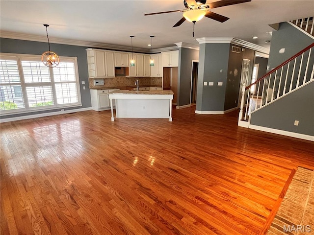 114 Cloverleaf Meadows Ct, Ofallon, MO 63366 - unfurnished living room featuring a ceiling fan, wood finished floors, stairs, and ornamental molding