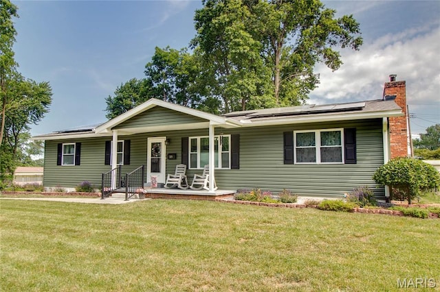 109 Hawbrook Pl, Jerseyville, IL 62052 - ranch-style house featuring covered porch, roof mounted solar panels, a front yard, and a chimney