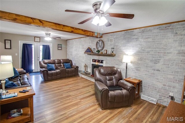 109 Hawbrook Pl, Jerseyville, IL 62052 - living room with a ceiling fan, light wood-style floors, a fireplace, beamed ceiling, and french doors