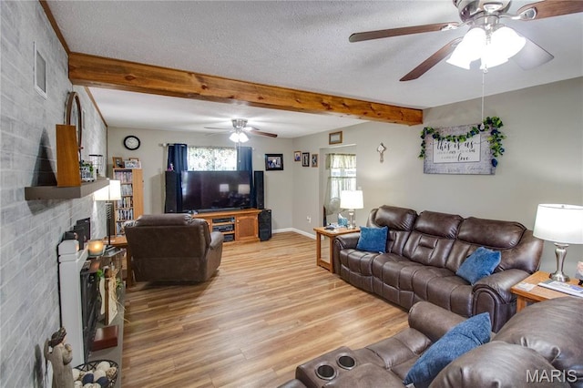 109 Hawbrook Pl, Jerseyville, IL 62052 - living room featuring ceiling fan, a brick fireplace, light wood-type flooring, beamed ceiling, and a textured ceiling