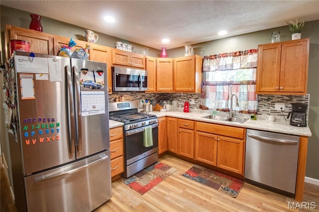 109 Hawbrook Pl, Jerseyville, IL 62052 - kitchen with stainless steel appliances, light wood finished floors, light countertops, tasteful backsplash, and a textured ceiling