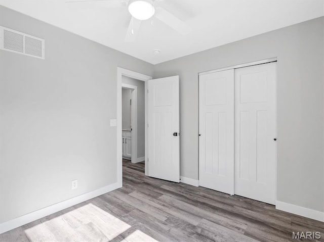 1505 Cypress Dr, Pacific, MO 63069 - unfurnished bedroom with wood finished floors, a closet, and a ceiling fan