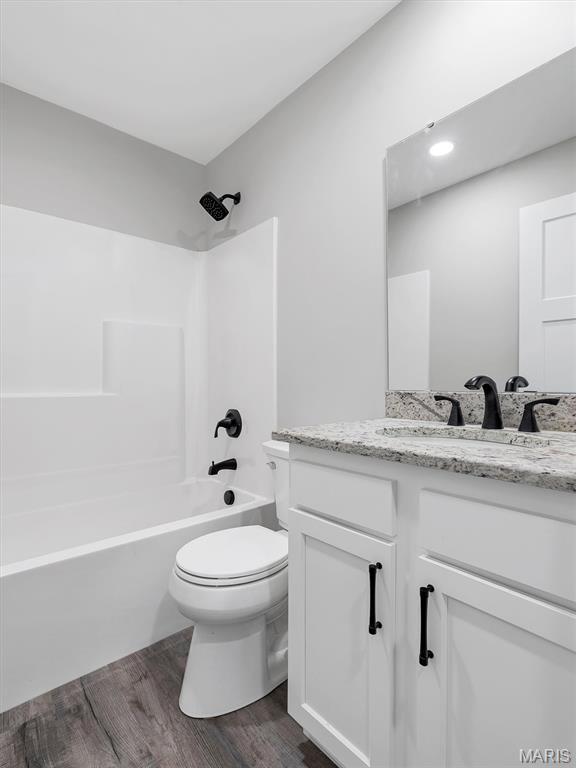 1505 Cypress Dr, Pacific, MO 63069 - full bathroom featuring vanity, shower / bathtub combination, and wood finished floors
