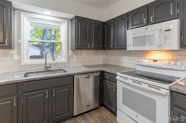 525 Oak Hill Dr, Lake St Louis, MO 63367 - kitchen with white appliances, light wood-type flooring, decorative backsplash, and light stone counters