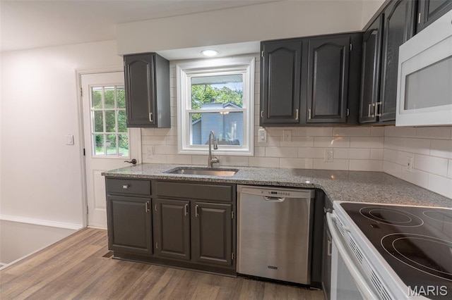 525 Oak Hill Dr, Lake St Louis, MO 63367 - kitchen featuring white appliances, wood finished floors, backsplash, and light stone counters