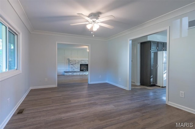 525 Oak Hill Dr, Lake St Louis, MO 63367 - unfurnished room featuring ceiling fan, dark wood finished floors, crown molding, and a fireplace