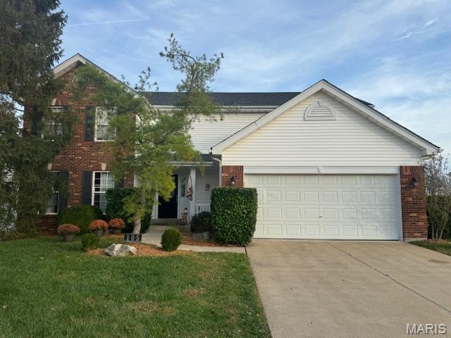 105 Royallmanor Ln, Ofallon, MO 63368 - view of front facade featuring brick siding, driveway, an attached garage, and a front lawn