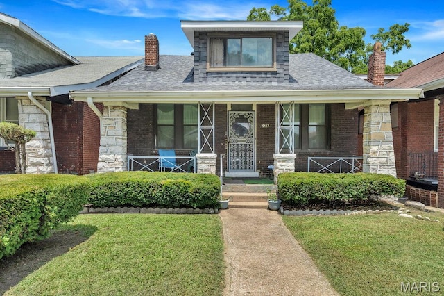 5447 Claxton Ave, Saint Louis, MO 63120 - view of front of home featuring a chimney, a front lawn, a shingled roof, and covered porch