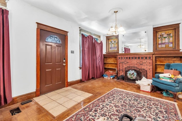 5447 Claxton Ave, Saint Louis, MO 63120 - entrance foyer featuring a chandelier and baseboards