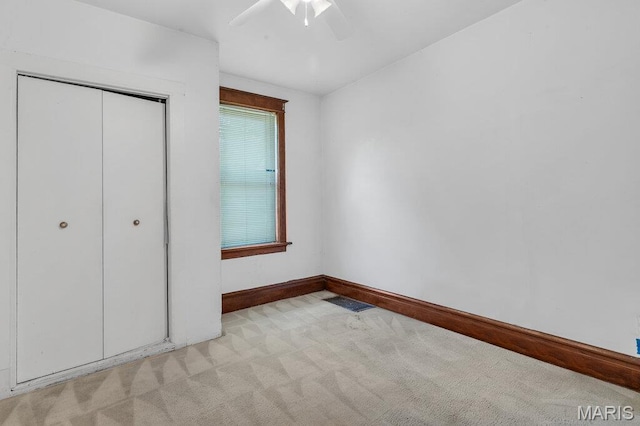 5447 Claxton Ave, Saint Louis, MO 63120 - unfurnished bedroom featuring light colored carpet, a closet, and ceiling fan