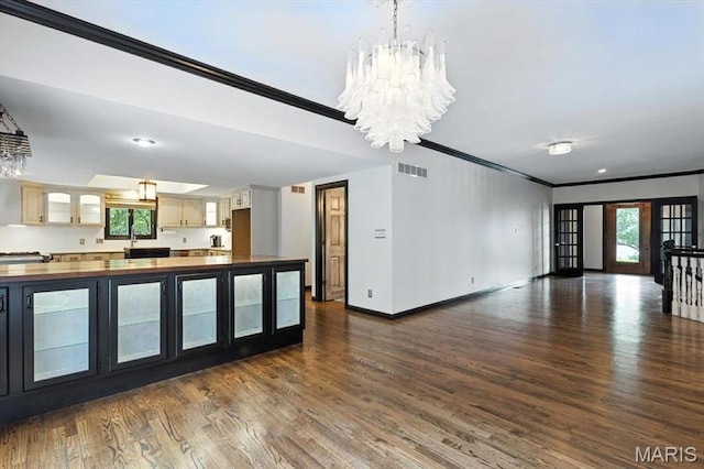 512 Overlook Terrace Ct, Eureka, MO 63025 - kitchen with butcher block counters, ornamental molding, glass insert cabinets, dark wood-style flooring, and a chandelier