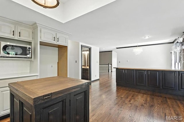 512 Overlook Terrace Ct, Eureka, MO 63025 - kitchen with stainless steel microwave, butcher block countertops, dark wood-style flooring, and a center island