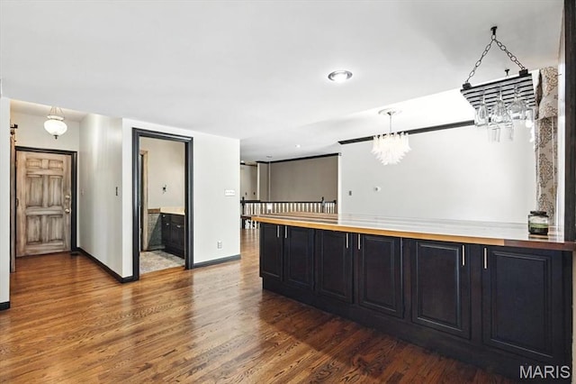 512 Overlook Terrace Ct, Eureka, MO 63025 - kitchen featuring a chandelier, dark cabinetry, wood finished floors, and decorative light fixtures