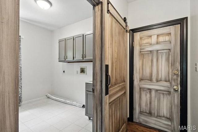 512 Overlook Terrace Ct, Eureka, MO 63025 - laundry area featuring hookup for an electric dryer, hookup for a washing machine, cabinet space, a barn door, and light tile patterned flooring