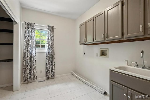 512 Overlook Terrace Ct, Eureka, MO 63025 - washroom with hookup for an electric dryer, hookup for a washing machine, cabinet space, and light tile patterned flooring