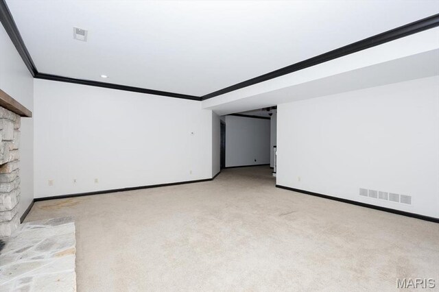 512 Overlook Terrace Ct, Eureka, MO 63025 - empty room featuring crown molding, light colored carpet, and a fireplace with raised hearth