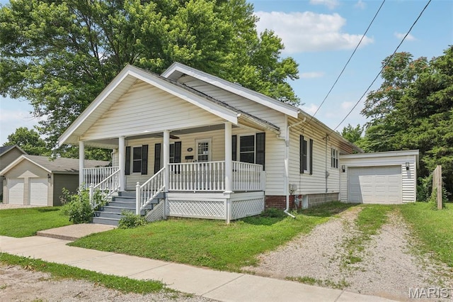 413 E Beach St, Litchfield, IL 62056 - bungalow-style home with driveway, covered porch, an outdoor structure, and a front yard