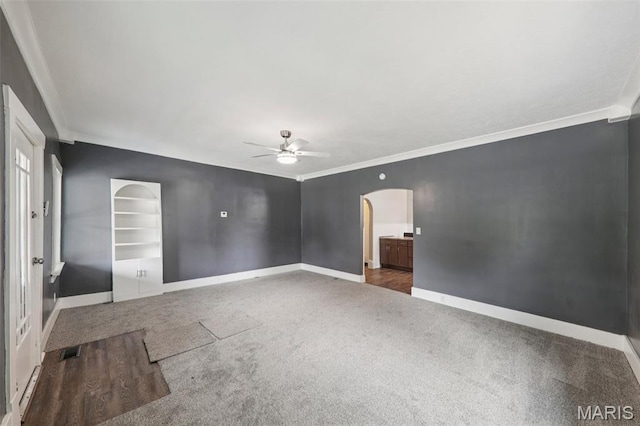 413 E Beach St, Litchfield, IL 62056 - empty room with ornamental molding, carpet flooring, a ceiling fan, and arched walkways