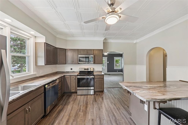 413 E Beach St, Litchfield, IL 62056 - kitchen with appliances with stainless steel finishes, arched walkways, dark wood finished floors, ceiling fan, and plenty of natural light