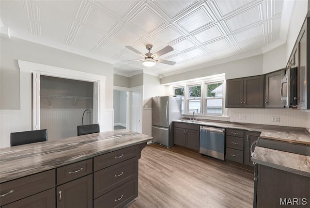 413 E Beach St, Litchfield, IL 62056 - kitchen featuring appliances with stainless steel finishes, ceiling fan, light wood-style floors, dark brown cabinets, and an ornate ceiling