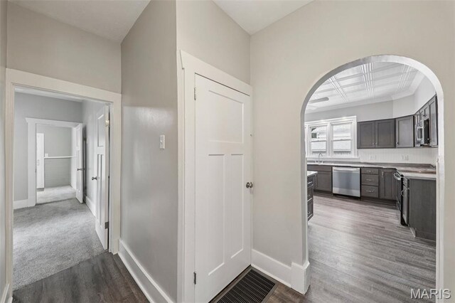 413 E Beach St, Litchfield, IL 62056 - hallway featuring arched walkways and dark wood-style floors