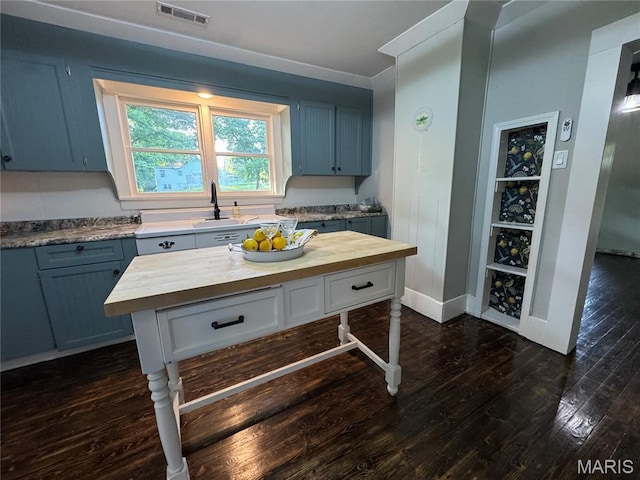 719 N 10th St, Poplar Bluff, MO 63901 - kitchen with wooden counters and dark wood finished floors