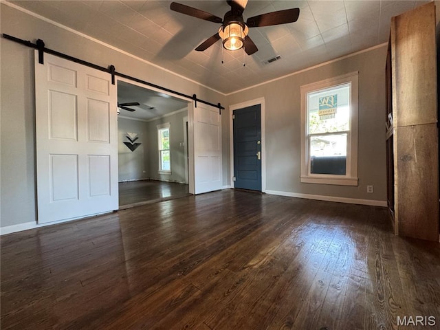 719 N 10th St, Poplar Bluff, MO 63901 - unfurnished room with a barn door, ornamental molding, a ceiling fan, and dark wood-type flooring