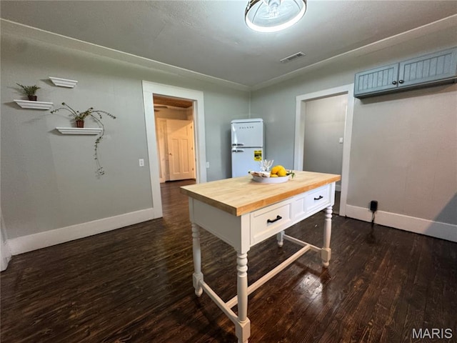 719 N 10th St, Poplar Bluff, MO 63901 - kitchen with wood counters, dark wood-style floors, and freestanding refrigerator