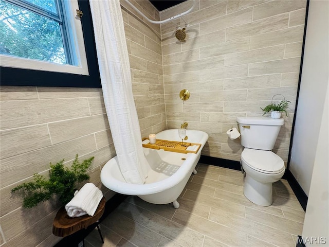 719 N 10th St, Poplar Bluff, MO 63901 - full bath featuring tile walls and a combined bath / shower with freestanding tub