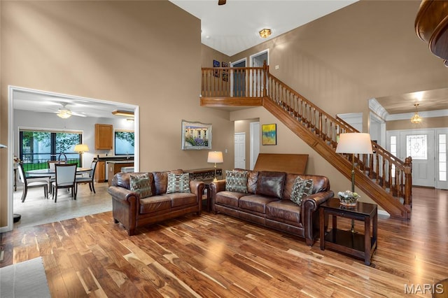 2260 Crimson View Dr, Wildwood, MO 63011 - living room featuring stairway, wood finished floors, plenty of natural light, a high ceiling, and ceiling fan