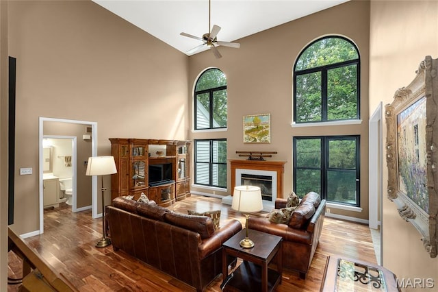 2260 Crimson View Dr, Wildwood, MO 63011 - living area with high vaulted ceiling, a glass covered fireplace, wood finished floors, and ceiling fan