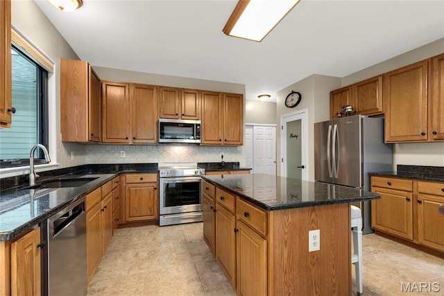 2260 Crimson View Dr, Wildwood, MO 63011 - kitchen with stainless steel appliances, decorative backsplash, a kitchen island, and dark stone countertops