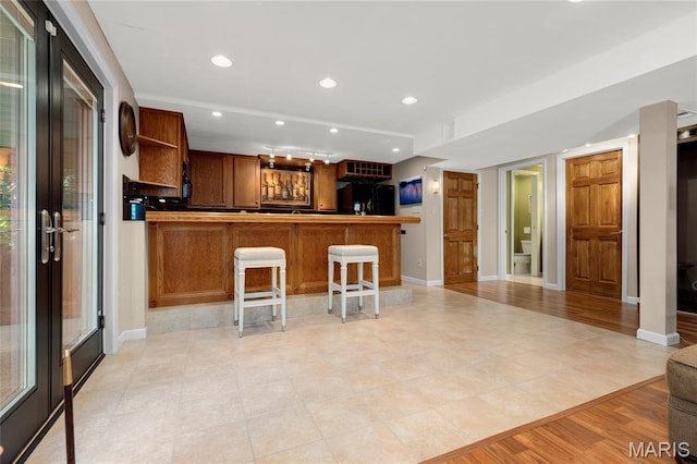 2260 Crimson View Dr, Wildwood, MO 63011 - kitchen with freestanding refrigerator, open shelves, a peninsula, recessed lighting, and a breakfast bar