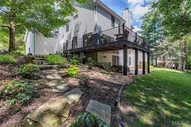2260 Crimson View Dr, Wildwood, MO 63011 - rear view of property featuring a lawn, a chimney, a wooden deck, and a patio area