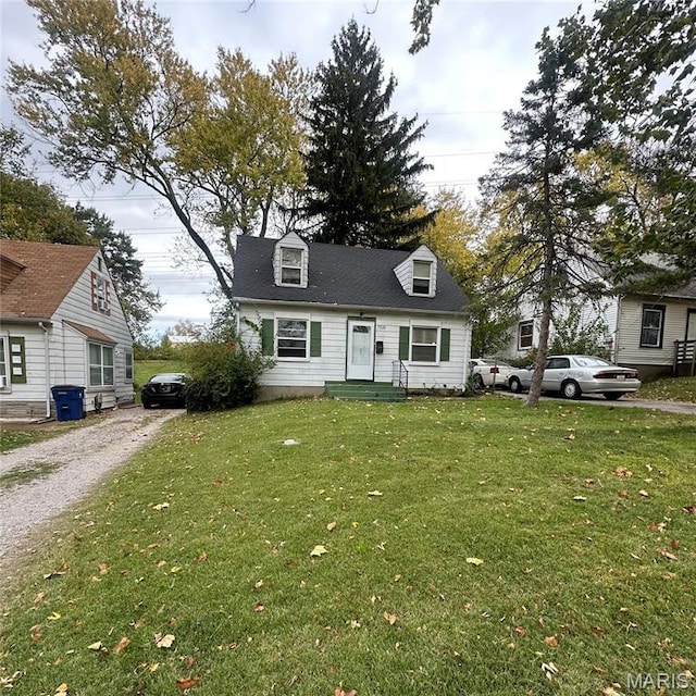 7231 Teal Ave, Normandy, MO 63133 - new england style home featuring a front lawn and driveway