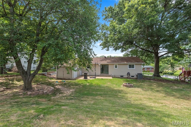 1117 Nelda Dr, Imperial, MO 63052 - back of house with an outdoor fire pit, a yard, and a garage