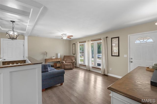 1117 Nelda Dr, Imperial, MO 63052 - living area featuring dark wood-style flooring, a ceiling fan, and a chandelier